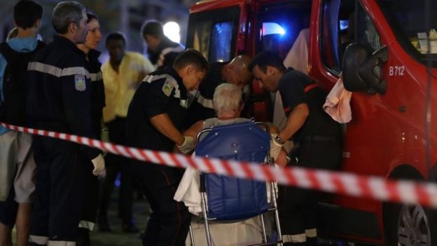 Emergency workers help an injured woman in Nice