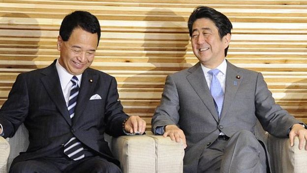 Japan's economy minister Akira Amari and Prime Minister Shinzo Abe