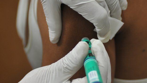 A person receives an insulin shot