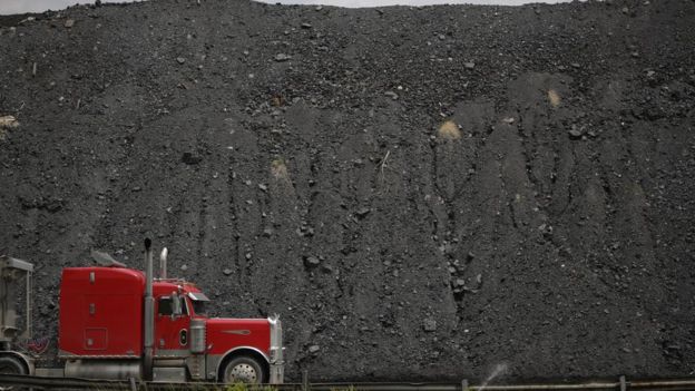 A tractor trailer drives by a mound of coal after delivering a truckload of coal to Arch Coal Terminals June 3, 2014 in Cattletsburg, Kentucky. New regulations on carbon emissions proposed by the Obama administration have reportedly angered politicians on both sides of the aisle in energy-producing states such as Kentucky and West Virginia