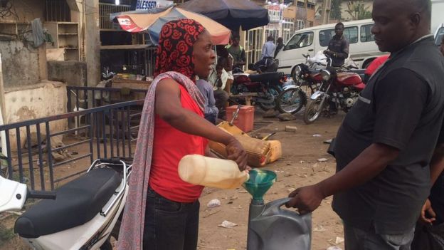 A woman selling petrol on the black market
