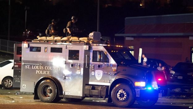 St Louis County police officers respond after shots were fired during a protest march on August 9, 2015 on West Florissant Avenue in Ferguson, Missouri.