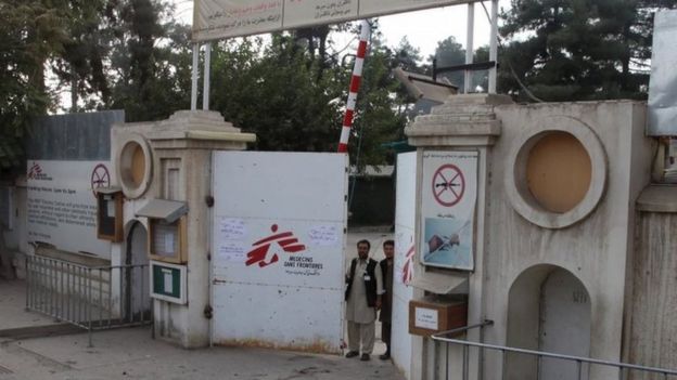 Afghan guards stand at the gate of Medecins Sans Frontieres (MSF) hospital after an air strike in the city of Kunduz, Afghanistan October 3, 2015.