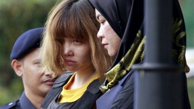 Vietnamese suspect Doan Thi Huong, center, in the ongoing assassination investigation, is escorted by police officers out from Sepang court in Sepang, Malaysia on Wednesday, March 1, 2017.