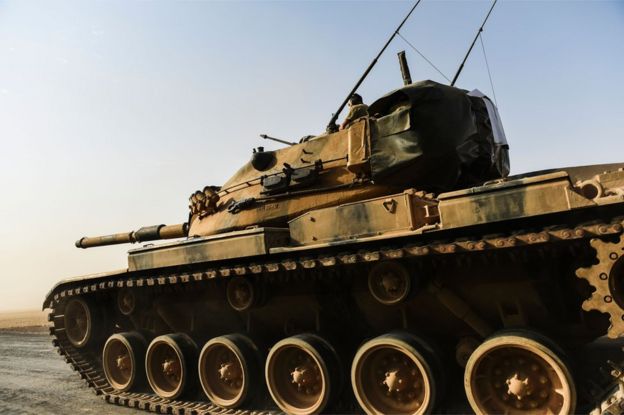 A Turkish tank moves towards the Syrian border at Karkamis, 24 August