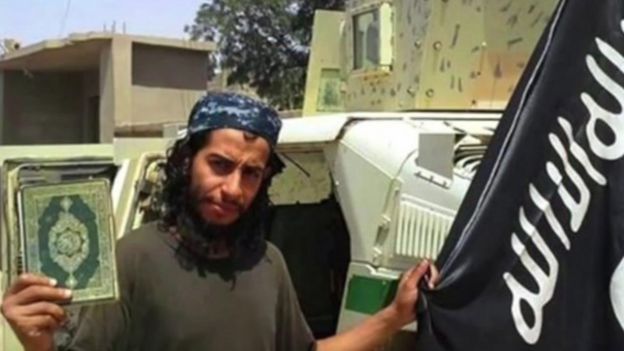 Abdelhamid Abaaoud in an undated photo with the Islamic State flag