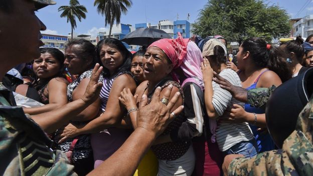 Local residents line up to receive food supplies in Manta, Ecuador on April 20, 2016