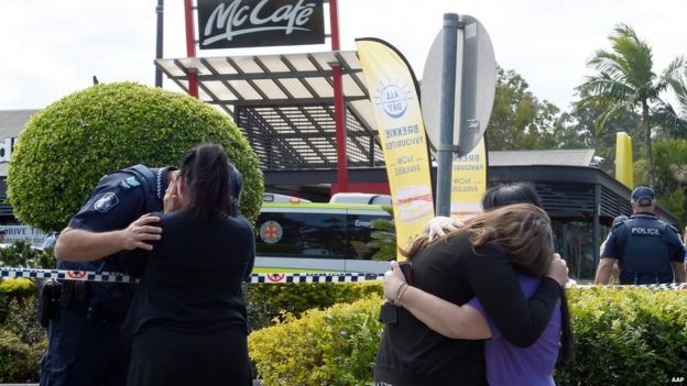 People react following a shooting at a McDonalds restaurant in Helensvale on the Gold Coast, Thursday, Sept. 10, 2015.