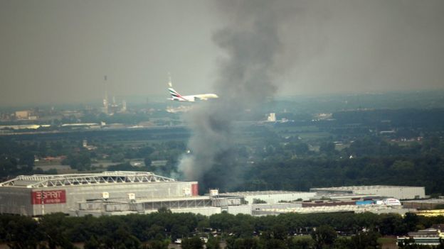 A cloud of smoke rises from the convention centre in Duesseldorf, Germany, on 7 June 2016