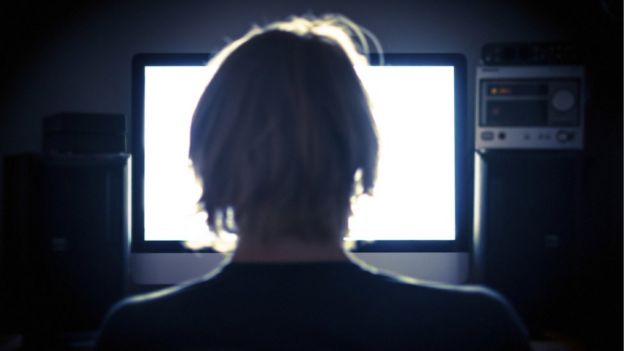 Anonymous back of head of man looking at computer