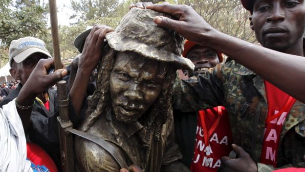 Members of the Mau Mau War Veterans Association (MMWVA) pose for photographs after the inauguration of a memorial to victims of torture and ill-treatment by the British colonialists during colonial rule