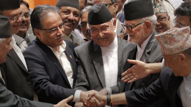 Nepal's Prime Minister Sushil Koirala, right, Communist Party of Nepal (Unified Marxist-Leninist), also known as CPN-UML leader K.P. Oli, center, and Communist Party of Nepal (Maoist) Chairman Pushpa Kamal Dahal, left, shake hands after the final constitution process at Constitution Assembly hall in Kathmandu, Nepal, Wednesday, Sept. 16, 2015