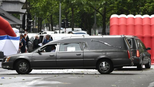 Hearses are parked near a police tent at the scene where a gunman shot dead two police officers and a bystander in the eastern Belgian city of Liege, 29 May 2018