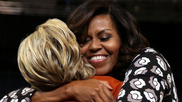 Clinton and Obama embrace as they arrive in Winston-Salem