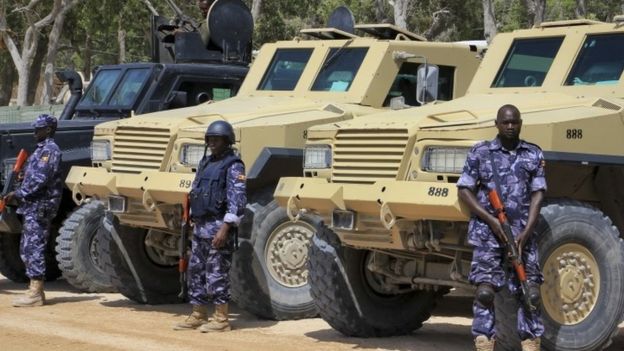 Amisom troops beside armoured vehicles