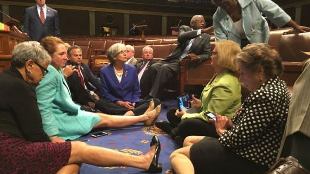 Congressmen sitting on the floor of the House