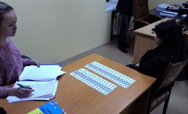 Teacher (right) under arrest in Ukraine