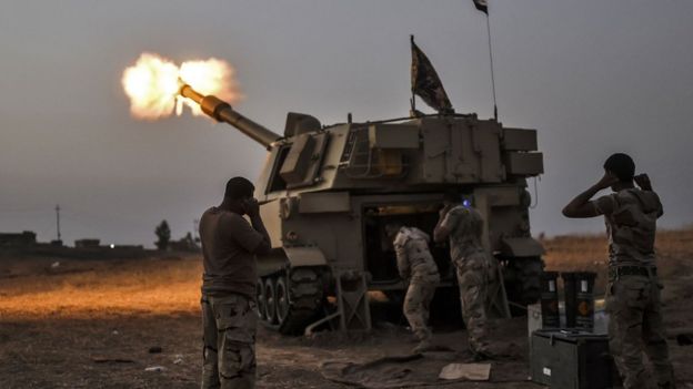 Iraqi forces fire shells on a village near Mosul