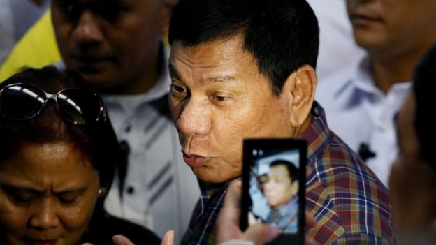 Rodrigo Duterte talks to the media after welcoming Overseas Filipino Workers who were repatriated back to the country Wednesday, Aug. 31, 2016