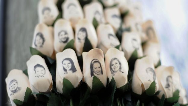 White roses with the faces of victims of the Sandy Hook Elementary School shooting