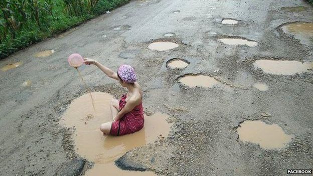 Woman bathing in a pothole in Thailand