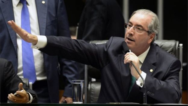 The president of the Chamber of Deputies Eduardo Cunha -who earlier this month had been indicted by the Supreme Court of taking $5 million in bribes as part of a vast embezzlement and bribery network centered on the country's national oil company Petrobras- gestures during the session in Brasilia on March 17, 2016