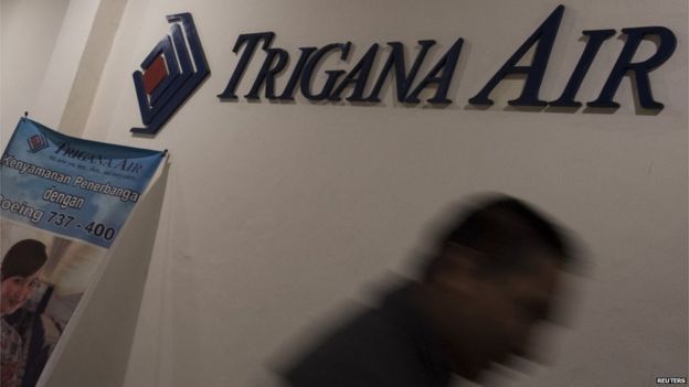 A man walks past the Trigana Air Services logo at the airlines office in Jakarta 16 August 2015 in this photo taken by Antara Foto.
