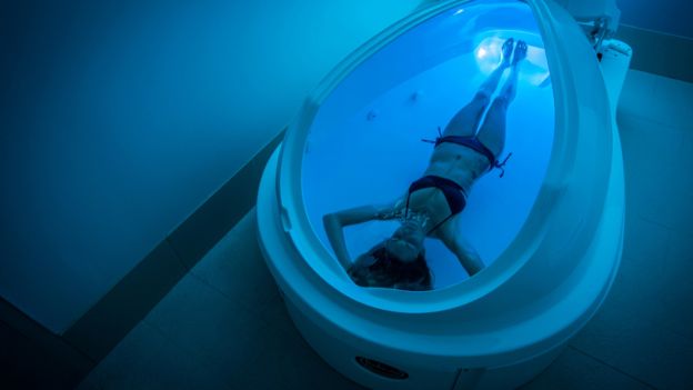 Woman lying down in flotation tank