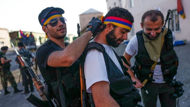 Gunmen wear Armenian national colours as they guard a seized police station in Yerevan, 23 July 2016