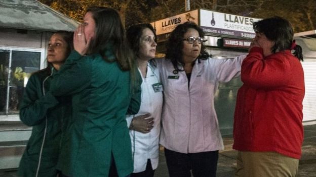 Women stand on a street in Santiago after the earthquake. Photo: 16 September 2015