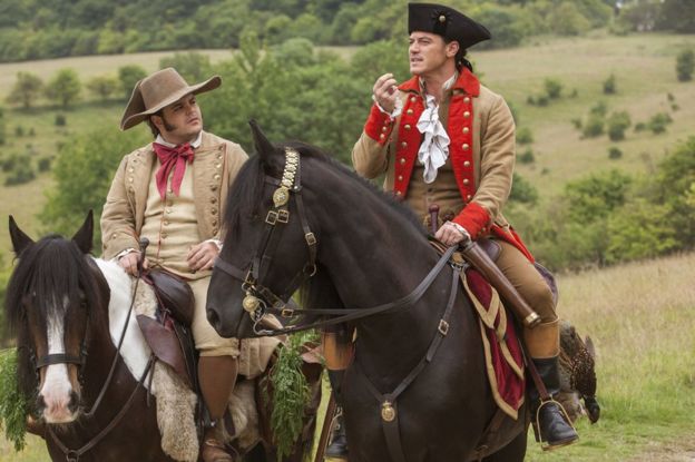 Josh Gad as LeFou, left, and Luke Evans as Gaston in Beauty and the Beast