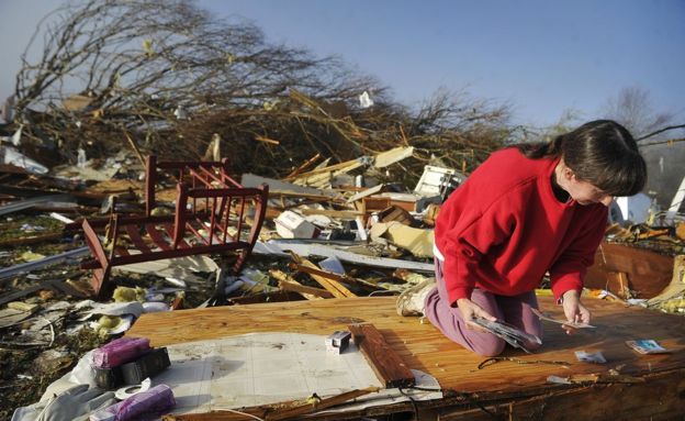 Diana Davis looks for family photos in the rubble of her father-in-law's home in Lutts, Tennessee (Photo by Larry McCormack/The Tennessean)