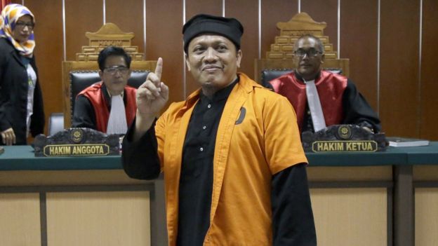 Islamic militant Ali Hamka gestures as he enters a courtroom prior to the start of his sentencing hearing at West Jakarta District Court in Jakarta, Indonesia, Thursday, Oct. 20, 2016.