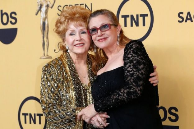 Actress Debbie Reynolds poses with her daughter actress Carrie Fisher backstage after accepting her Lifetime Achievement award at the 21st annual Screen Actors Guild Awards in Los Angeles, California January 25, 2015.