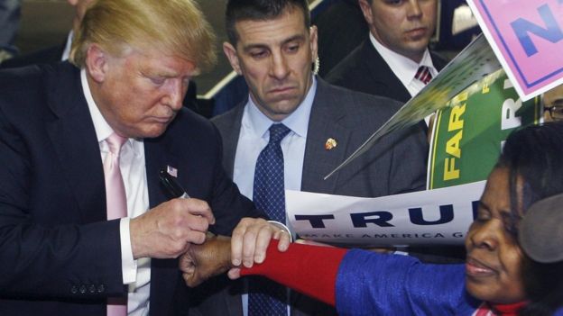 Donald Trump signs the hand of a voter in Valdosta, Georgia, 29 February