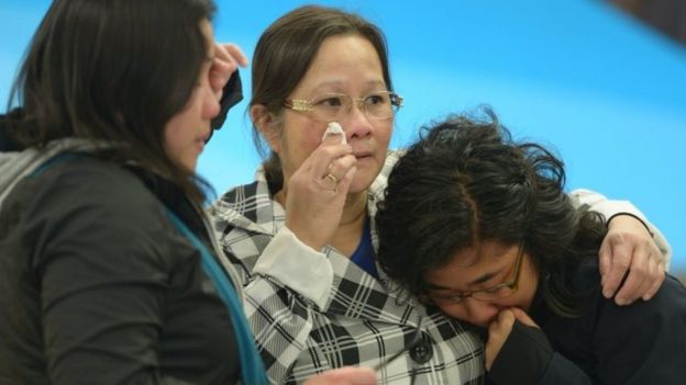 A mother (centre) is greeted by her daughters after arriving in Edmonton from the Fort McMurray area. Photo: 5 May 2016