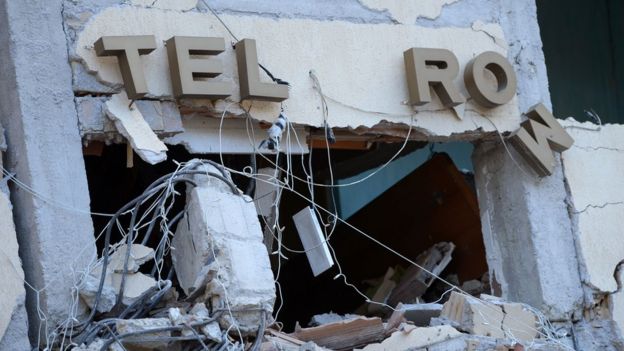 The damaged sign at the Hotel Rome, in Amatrice