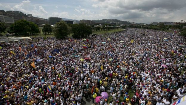 A mass of people take a highway during a protest against President Nicolas Maduro in Caracas, Venezuela, Wednesday, Oct. 26, 2016.