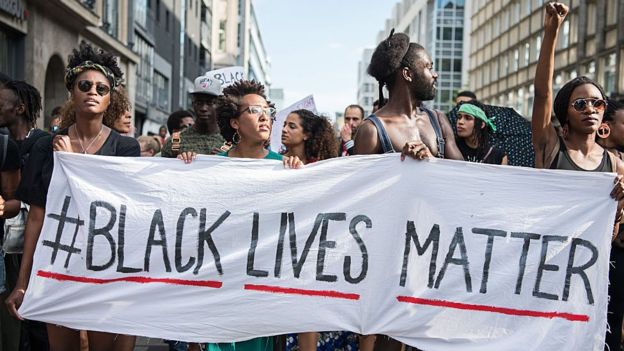 Protestors hold a banner reading 'Black Lives Matter' during a demonstration in Berlin, on July 10, 2016 with the motto 'Black Lives Matter - No Justice = No Peace' as protest over the deaths of two black men at the hands of police last week.