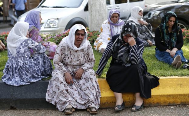 Women wait outside a morgue in the Turkish city of Gaziantep, 21 August
