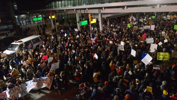 Protestors rally during a demonstration against the new immigration ban issued by President Donald Trump at John F. Kennedy International Airport on January 28, 2017 in New York City.