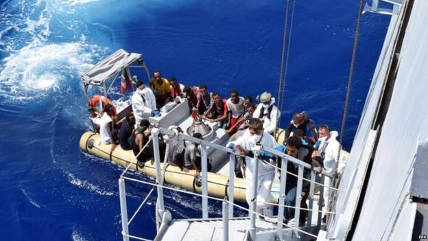 A boat crowded with refugees off the Italian coast in the Strait of Sicily, 22 August