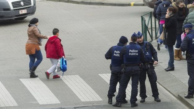 A pupil (in red coat) walks in Forest as police secure the area. Photo: 15 March 2016