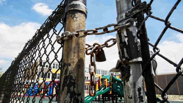 A playground is seen behind a locked gate at Woods Elementary Math and Science Academy in Chicago