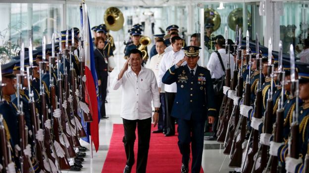 Philippine President Rodrigo Duterte reviews honour guards during a departure ceremony at the Manila International Airport, Philippines, 13 December 2016.