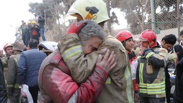 Firefighters react at the site of a collapsed high-rise building in Tehran, Iran (19 January 2017)