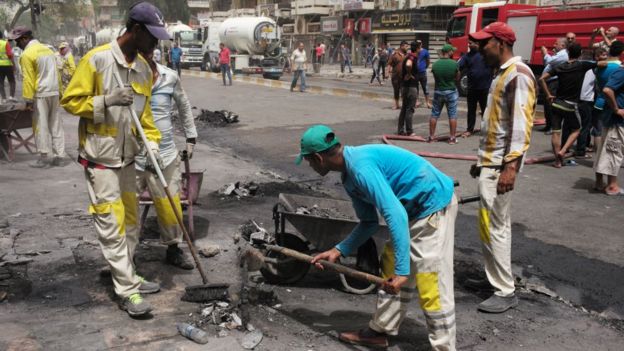 Workers clear up after bomb in Karrada, Baghdad. 3 July 2016