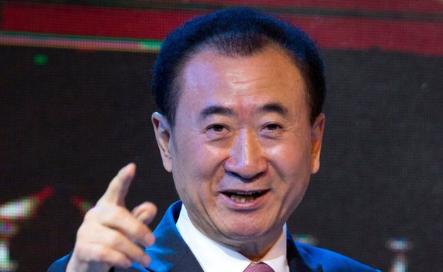 In this 16 June 2016 file photo, Wang Jianlin, chairman of Wanda Group, gestures as he speaks during a signing ceremony for a strategic partnership between FIBA and Wanda Group in Beijing