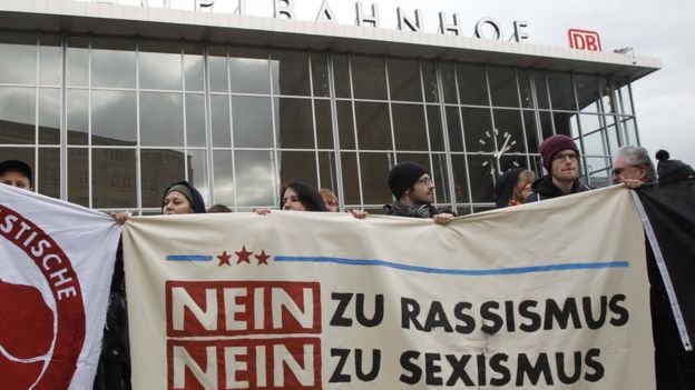 People protest in front of the main station in Cologne, Germany, on Wednesday, Jan. 6, 2016. The poster reads: 