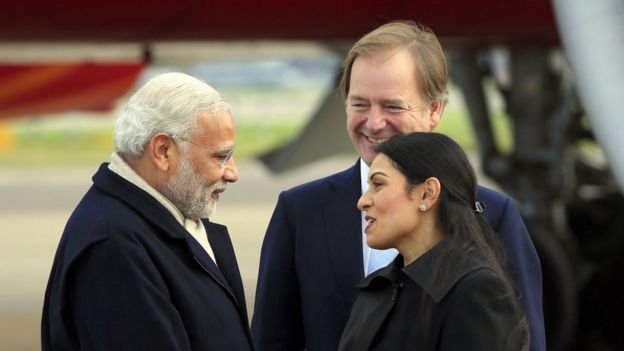 Narendra Modi at Heathrow, meeting ministers Hugo Swire and Priti Patel